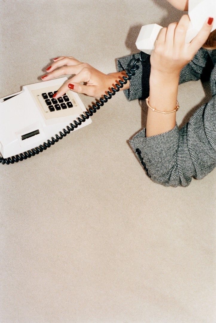 Hands dialing a rotary phone — an editorial reference to operational follow-through