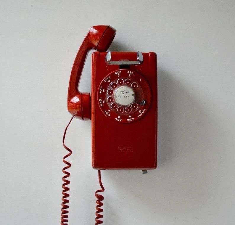 Vintage red rotary wall phone